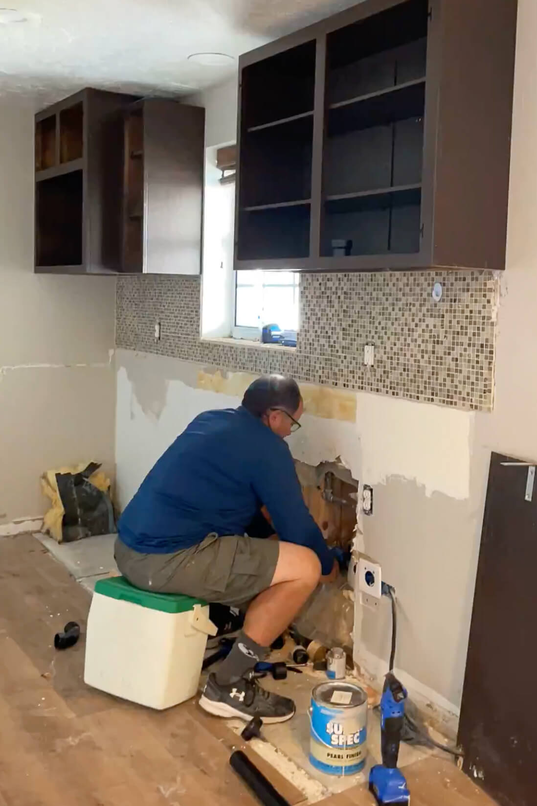 Moving plumbing and electrical lines to rearrange our kitchen.